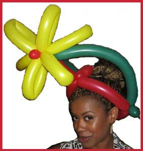 Balloon maker Daisy Doodle twists  flower hats at company party in Long Island NYC