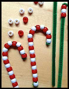 Kids string beads to make christmas candy canes as their craft project in Manhattan ny