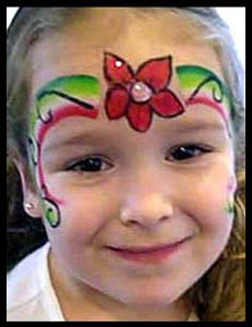 Girl is face painted with a Christmas poinsetta crown