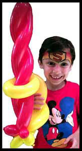 Boy with balloon twisted sword by balloonist Daisy Doodle for childrens birthday party entertainment Brooklyn NYC