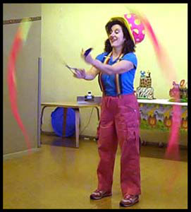 Kids performer Daisy Doodle swings poi balls at a toddler birthday party for 1 year old nyc