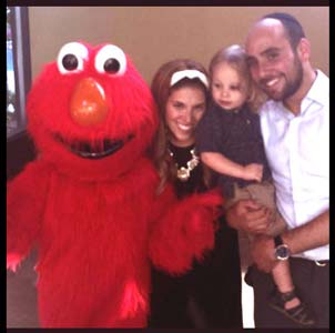 Elmo character poses for photos with family after birthday party entertainment in Brooklyn NYC