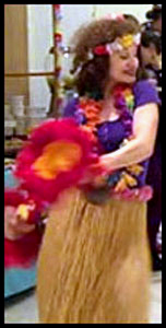 Daisy Doodle dances with feather gourds at hula show at Hawaiian party in Queens NYC