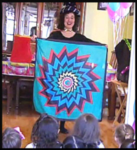 Magician Daisy Doodle produces colorful silk scarf during wizard magic show in Manhattan NYC